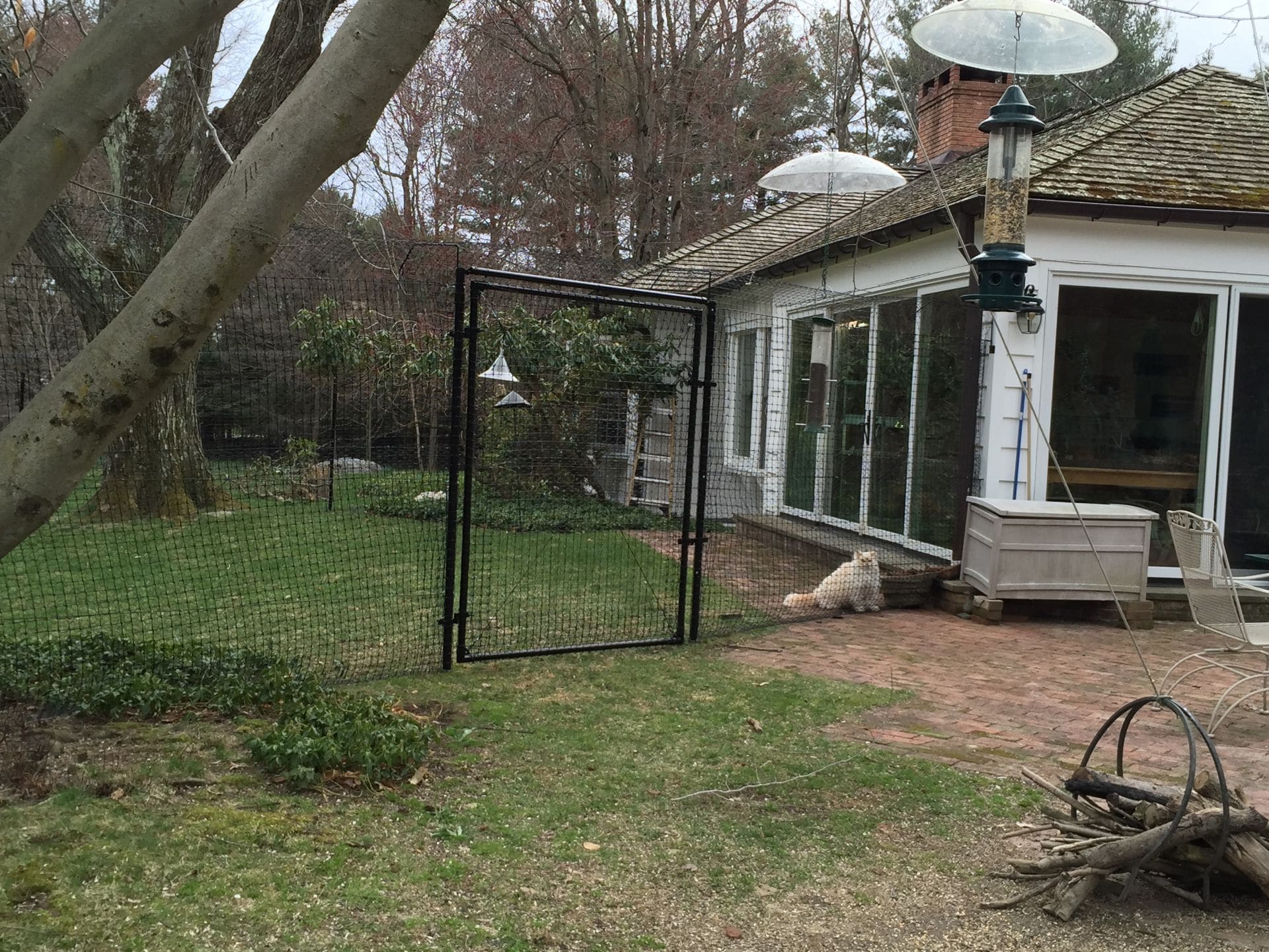 Professional fence with gate installed around a residential backyard
