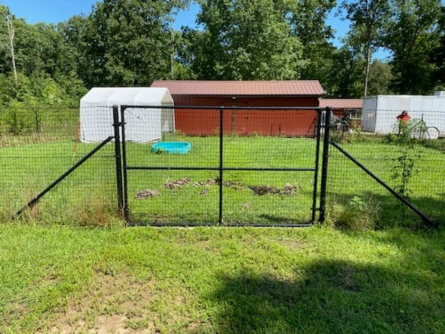 Existing metal fence posts reused with new professional-grade containment mesh installed over them